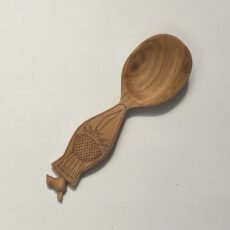 6” hand carved eating spoon with bird finial. Cherry with kolrose pattern and tung oil finish.